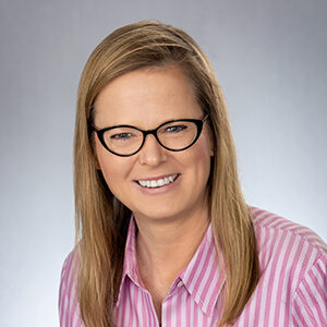 Zoe Heineman - women with glasses and pink striped shirt